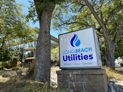 Long Beach Utilities sign with trees in front of building